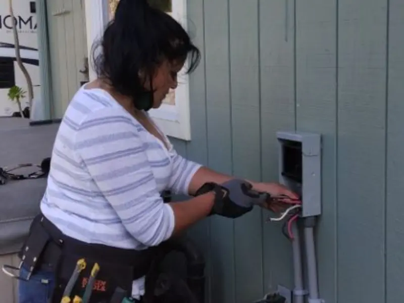 Licensed electrician wiring an exterior subpanel in Manvel