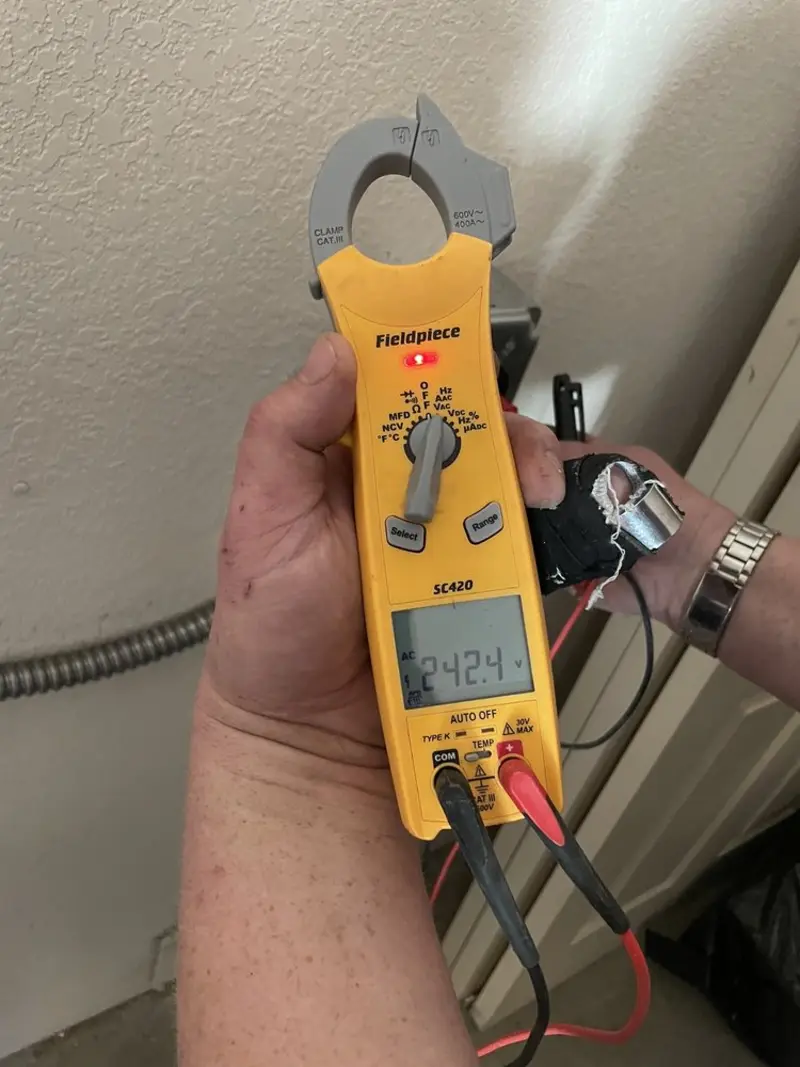 Voltage testing with clamp meter during Outlet Installation in Manvel
